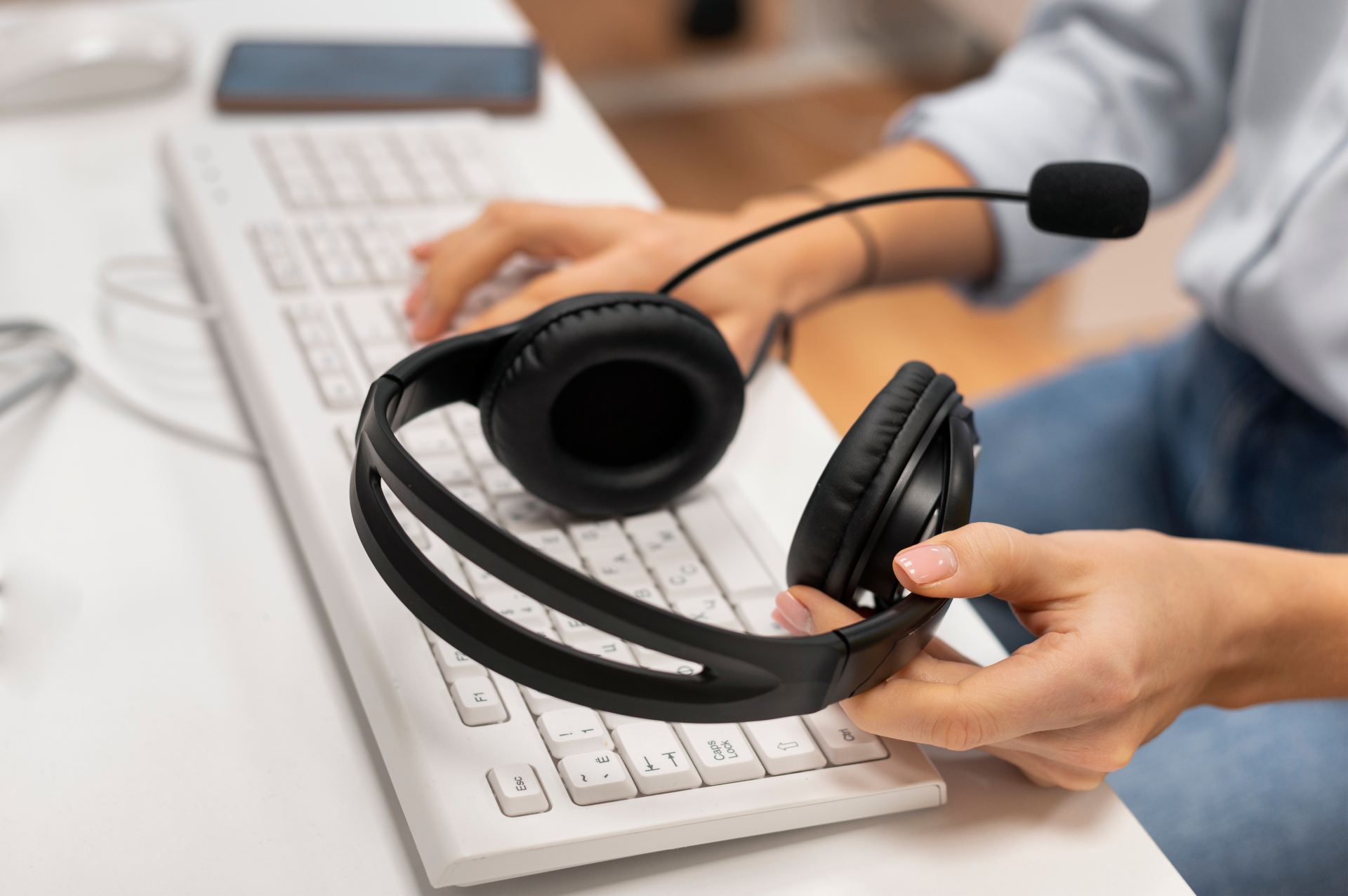 woman-working-call-center-holding-pair-headphones (1)